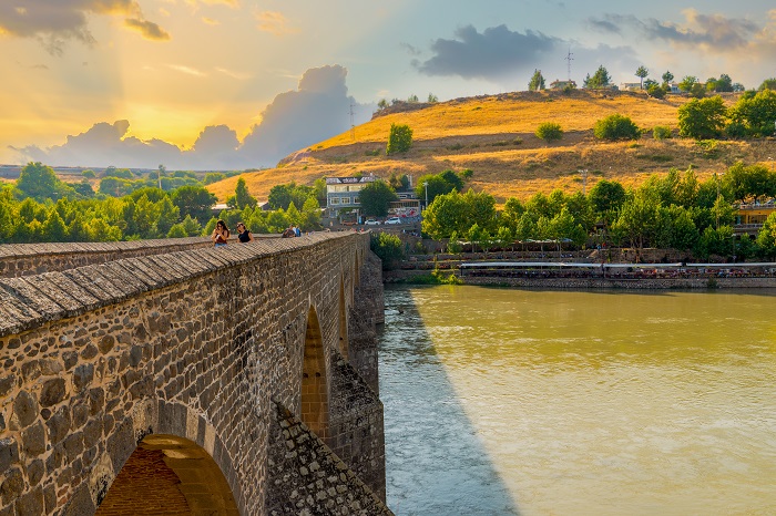 Diyarbakir, Turkey- September 17 2020: View of the Ten Eyed Bridge (On Gozlu Kopru in Turkish), historical bridge on Tigris River under sunset